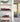 Red scale model racing cars displayed in clear acrylic cases on wooden shelves in a modern home setting