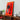 Red Ferrari LEGO car model mounted on an illuminated orange display frame on wooden shelf