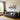 Modern living room with gray sofa, colorful cushions, indoor plants, and vibrant pop art wall painting