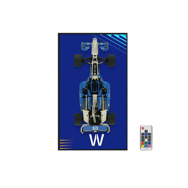 Top view of blue and white remote-controlled racing car model on blue background with remote control