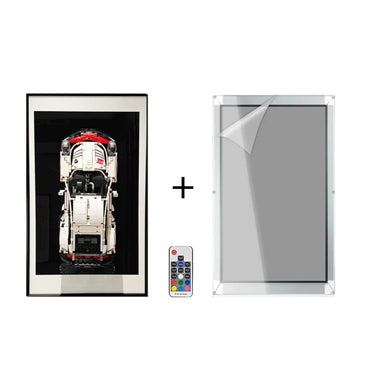 Framed LEGO Porsche model, remote control, and clear acrylic frame with protective film