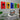 Modern workspace with white desk, iMac, plant, and colorful Lego car wall art panels