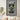 Framed wall art of a Peugeot 9X8 Le Mans race car model in gray and lime green, displayed above a sofa
