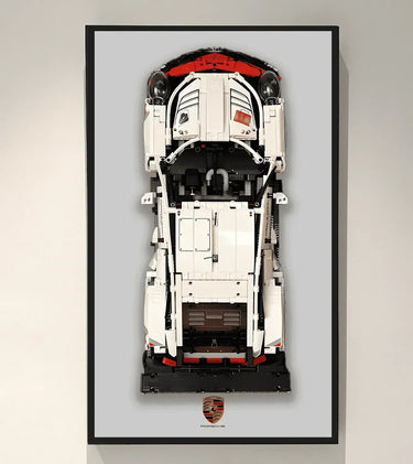 Framed top view of a white and red LEGO Porsche car model with Porsche logo below
