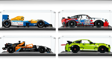 Four detailed LEGO race car models in clear display cases on black bases, featuring various colors and sponsor decals