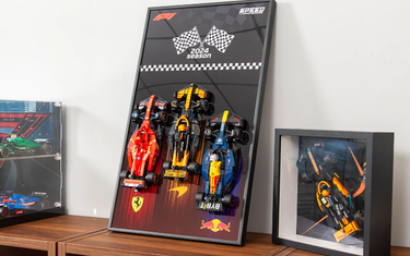 Framed 3D LEGO F1 2024 season models of Ferrari, McLaren, and Red Bull cars on a wooden shelf