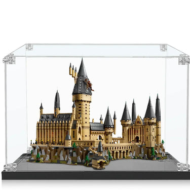 LEGO Hogwarts Castle model displayed in clear protective case with detailed turrets and rocky base