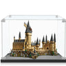 LEGO Hogwarts Castle model displayed in clear protective case with detailed turrets and rocky base