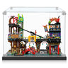 Lego cityscape diorama with bridge, red arch, buildings, and multiple minifigures in clear display case