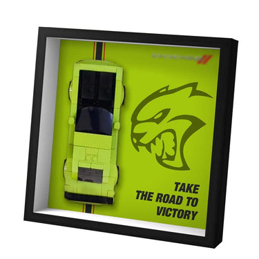 Framed lime green sports car model with aggressive panther logo and text 'Take the road to victory'