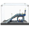 Miniature LEGO skate park with ramps, railings, lights, and small accessories inside a clear display case