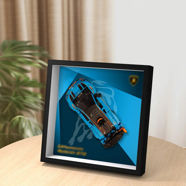 Framed display of blue LEGO Lamborghini Sian model on table with blurred background