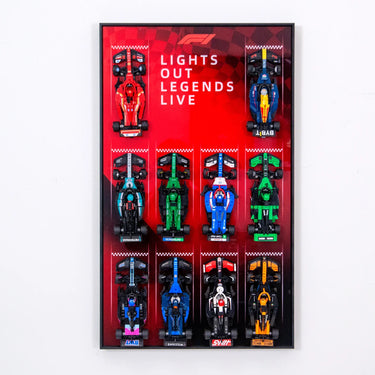 Framed display of 10 miniature F1 cars on red background with text 'Lights Out Legends Live'