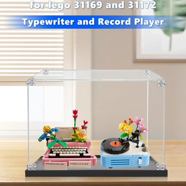 LEGO typewriter and record player set with colorful flowers displayed in clear acrylic case on wooden table