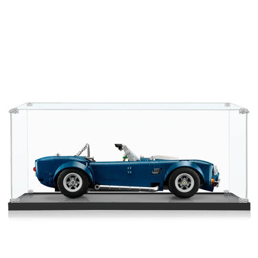 Blue classic convertible sports car model displayed inside clear glass showcase