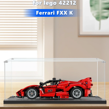 Red LEGO Ferrari FXX K model displayed in a clear acrylic display case on wood surface