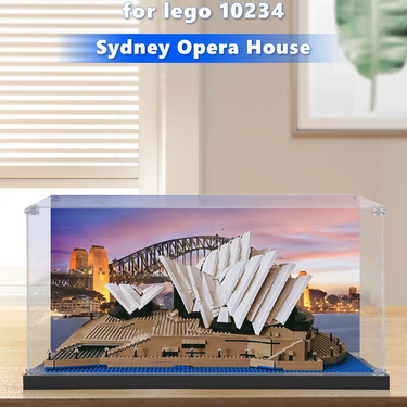 LEGO model of Sydney Opera House displayed in clear case on wooden table with sunset backdrop