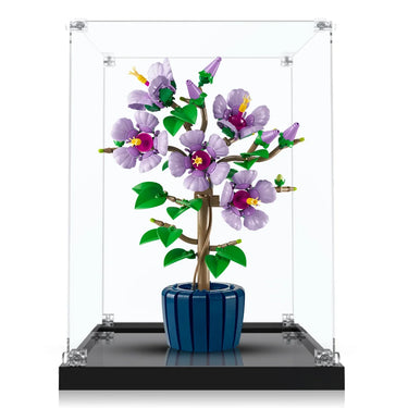 Purple LEGO flower bonsai in blue pot displayed inside clear glass case on black base