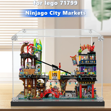 Lego Ninjago City Markets set 71799 displayed in clear protective case on wooden table with mini-figures and detailed building features
