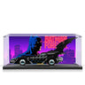 Lego Batman Forever Batmobile model in acrylic display case with neon cityscape backdrop