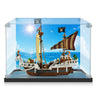 LEGO pirate ship model with mini figures in clear display case against ocean background