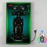 LEGO Mercedes AMG Petronas Formula One car model displayed on illuminated green light panel with remote control