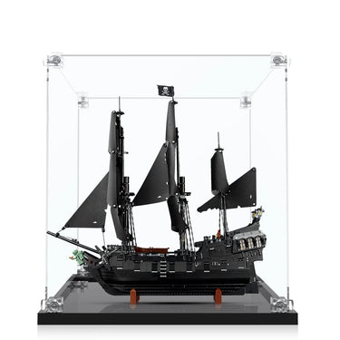 Black LEGO pirate ship model with tattered sails and Jolly Roger flag in clear display case