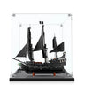 Black LEGO pirate ship model with tattered sails and Jolly Roger flag in clear display case