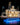 Illuminated detailed LEGO riverboat model on blue-lit stand with smokestacks and paddlewheel