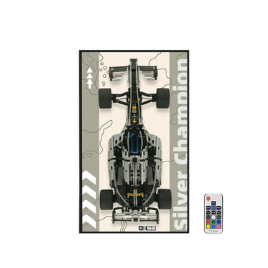 Top view of a black and gray Lego-style Silver Champion race car model with a remote control on white background