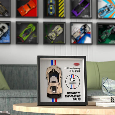 Framed model of classic EB110 car celebrating 110th brand anniversary on wooden table in modern living room