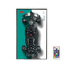 Top view of a black Petronas Formula 1 race car model with a split teal and white background and a remote control