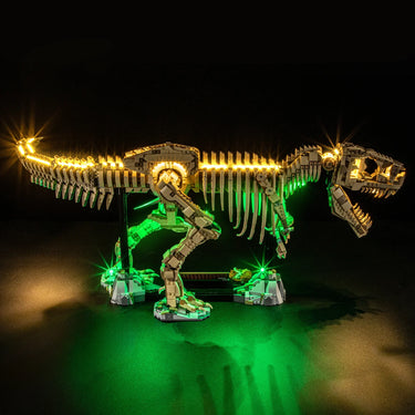 Illuminated LEGO dinosaur skeleton model with yellow and green LED lights on black background