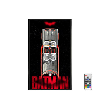Batman LEGO Batmobile model displayed vertically with red bat symbol and remote control
