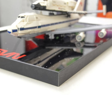 Close-up of Lego Space Shuttle model on a glossy black framed display stand
