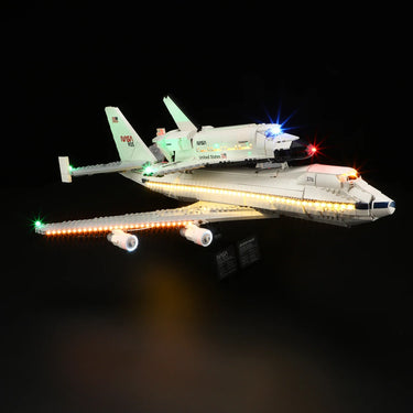 Illuminated LEGO NASA space shuttle model with detailed lights against black background