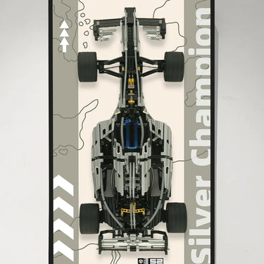 Top view of a silver and black LEGO Formula 1 model car with large tires on a beige and grey background poster labeled Silver Champion